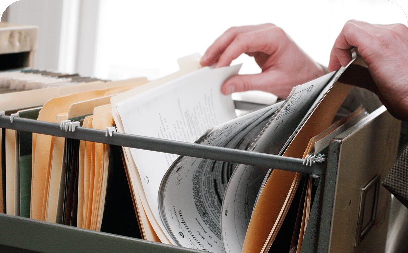 Person organizing documents in cabinet