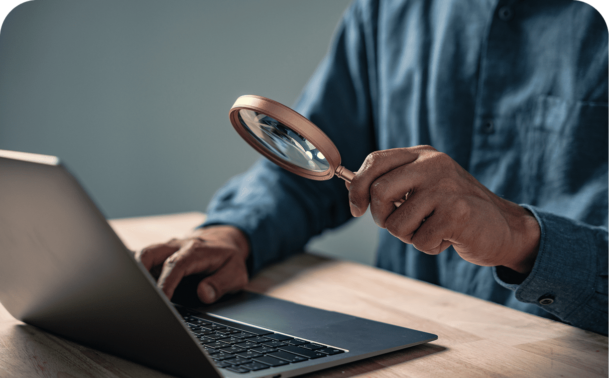 Close-up of laptop and magnifying glass